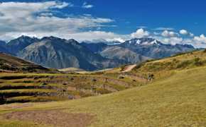 Ancient circular terraces of Moray unfold beneath snow-capped Andean peaks in the Sacred Valley. 