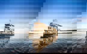 The Delfin III glides over glassy Amazon waters, offering luxury and adventure deep in the jungle.