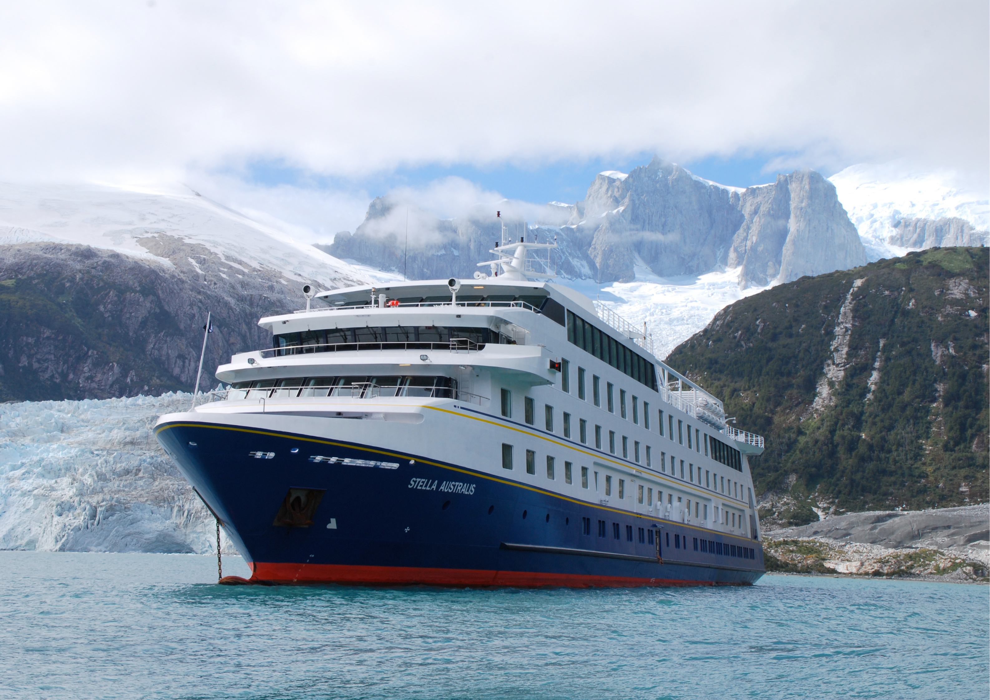 The Stella Australis cruise ship sails past icy waters and snow-covered peaks in the remote glacial fjords of Patagonia. 