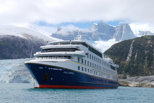 The Stella Australis cruise ship sails past icy waters and snow-covered peaks in the remote glacial fjords of Patagonia. 