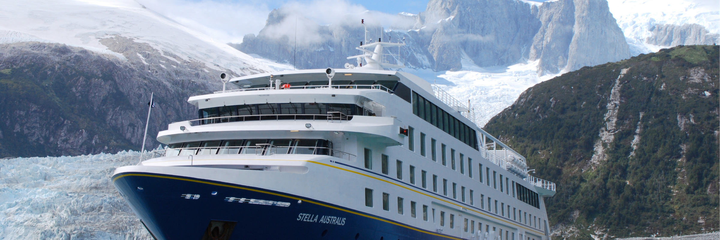 The Stella Australis cruise ship sails past icy waters and snow-covered peaks in the remote glacial fjords of Patagonia. 