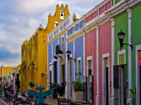 Colourful colonial street with pastel buildings and outdoor cafes in the historic center of Campeche, Mexico