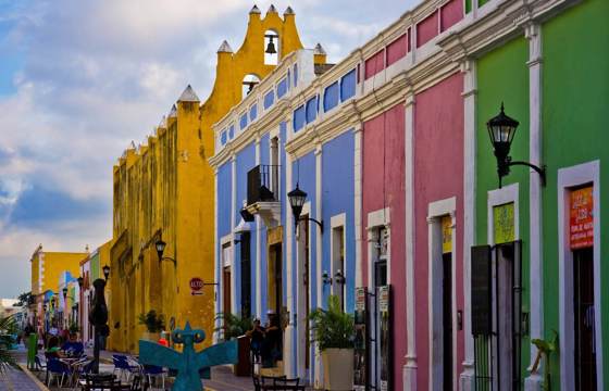 Colourful colonial street with pastel buildings and outdoor cafes in the historic center of Campeche, Mexico