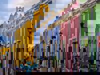 Colourful colonial street with pastel buildings and outdoor cafes in the historic center of Campeche, Mexico