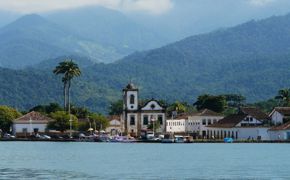 Colonial church and colourful waterfront houses in Paraty on Brazil's Costa Verde. 