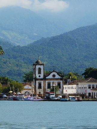 Colonial church and colourful waterfront houses in Paraty on Brazil's Costa Verde. 