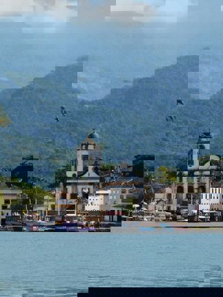 Colonial church and colourful waterfront houses in Paraty on Brazil's Costa Verde. 