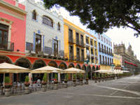 Colourful colonial buildings and outdoor cafes on the main square (Zocalo) in Puebla, Mexico. 