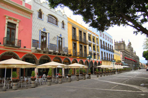 Colourful colonial buildings and outdoor cafes on the main square (Zocalo) in Puebla, Mexico. 