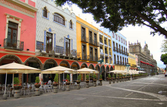 Colourful colonial buildings and outdoor cafes on the main square (Zocalo) in Puebla, Mexico.
