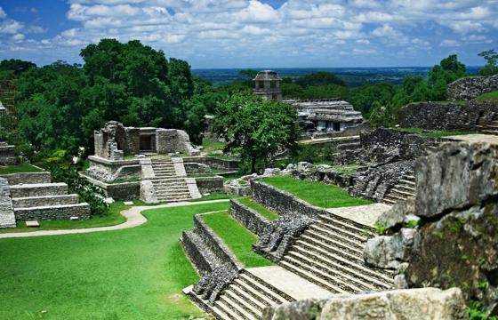 View of the ancient Mayan temples and ruins at Palenque, surrounded by jungle in Chiapas, Mexico. 
