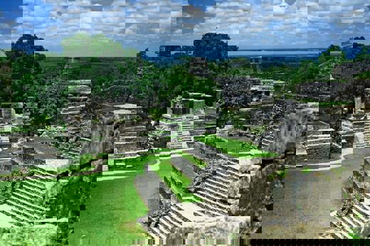 View of the ancient Mayan temples and ruins at Palenque, surrounded by jungle in Chiapas, Mexico. 