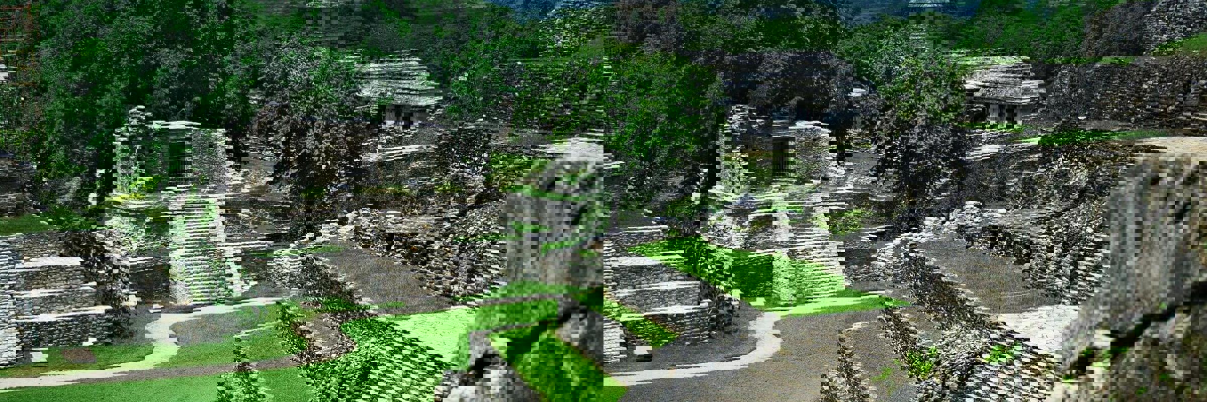 View of the ancient Mayan temples and ruins at Palenque, surrounded by jungle in Chiapas, Mexico. 