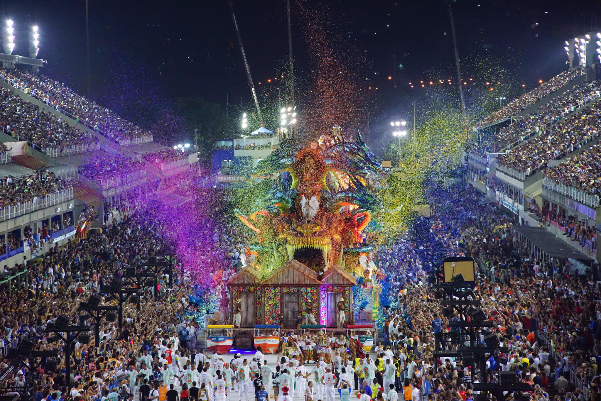 Vibrant night parade at the Sambadrome during Rio Carnival, with colourful floats and crowds in Rio de Janeiro, Brazil. 