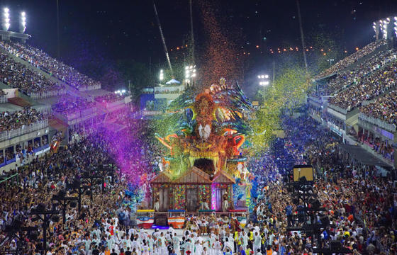 Vibrant night parade at the Sambadrome during Rio Carnival, with colourful floats and crowds in Rio de Janeiro, Brazil. 