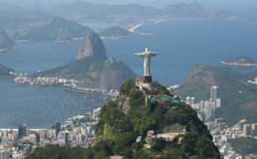 Christ the redeemer overlooks Rio and Sugarloaf Mountain on Brazil's coastline.