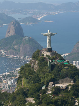 Christ the redeemer overlooks Rio and Sugarloaf Mountain on Brazil's coastline.
