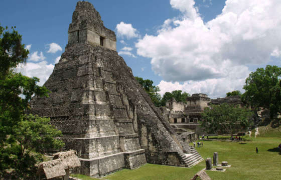 Central America, Guatemala - The towering Maya pyramid of Tikal rises above the lush jungle canopy. 