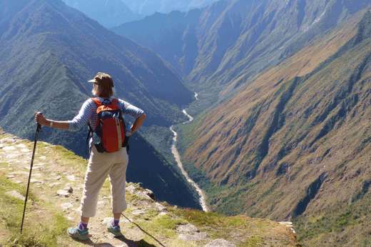 Hiker on the Inca overlooking Andes mountains near Machu Picchu, Peru adventure trek. 