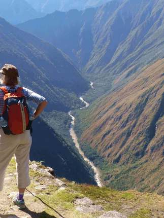 Hiker on the Inca overlooking Andes mountains near Machu Picchu, Peru adventure trek. 