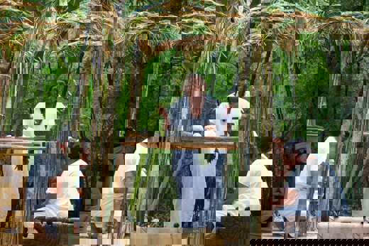 Mayan ritual performed in the Yucatan jungle with traditional attire, natural altar, and sacred elements. 