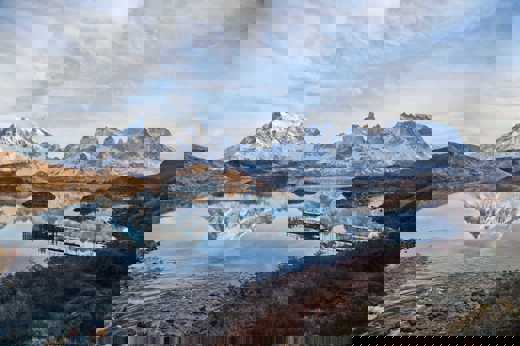 Cyrstal-clear Pehoe Lake reflects the jagged peaks of Torres del Paine, Chile. 
