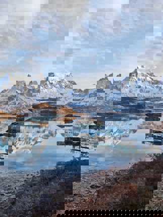 Cyrstal-clear Pehoe Lake reflects the jagged peaks of Torres del Paine, Chile. 