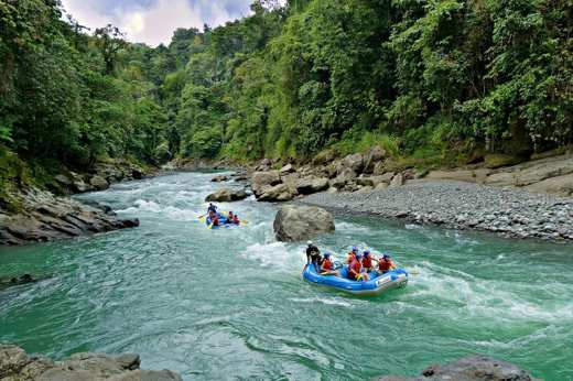 White-water rafting on the Pacuare River through lush rainforest in Costa Rica. 