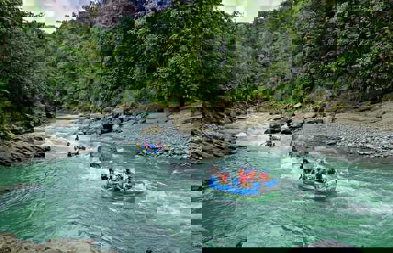 White-water rafting on the Pacuare River through lush rainforest in Costa Rica.