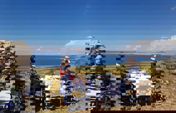 Private picnic setup with panoramic views of Lake Titicaca in the Peruvian highlands.