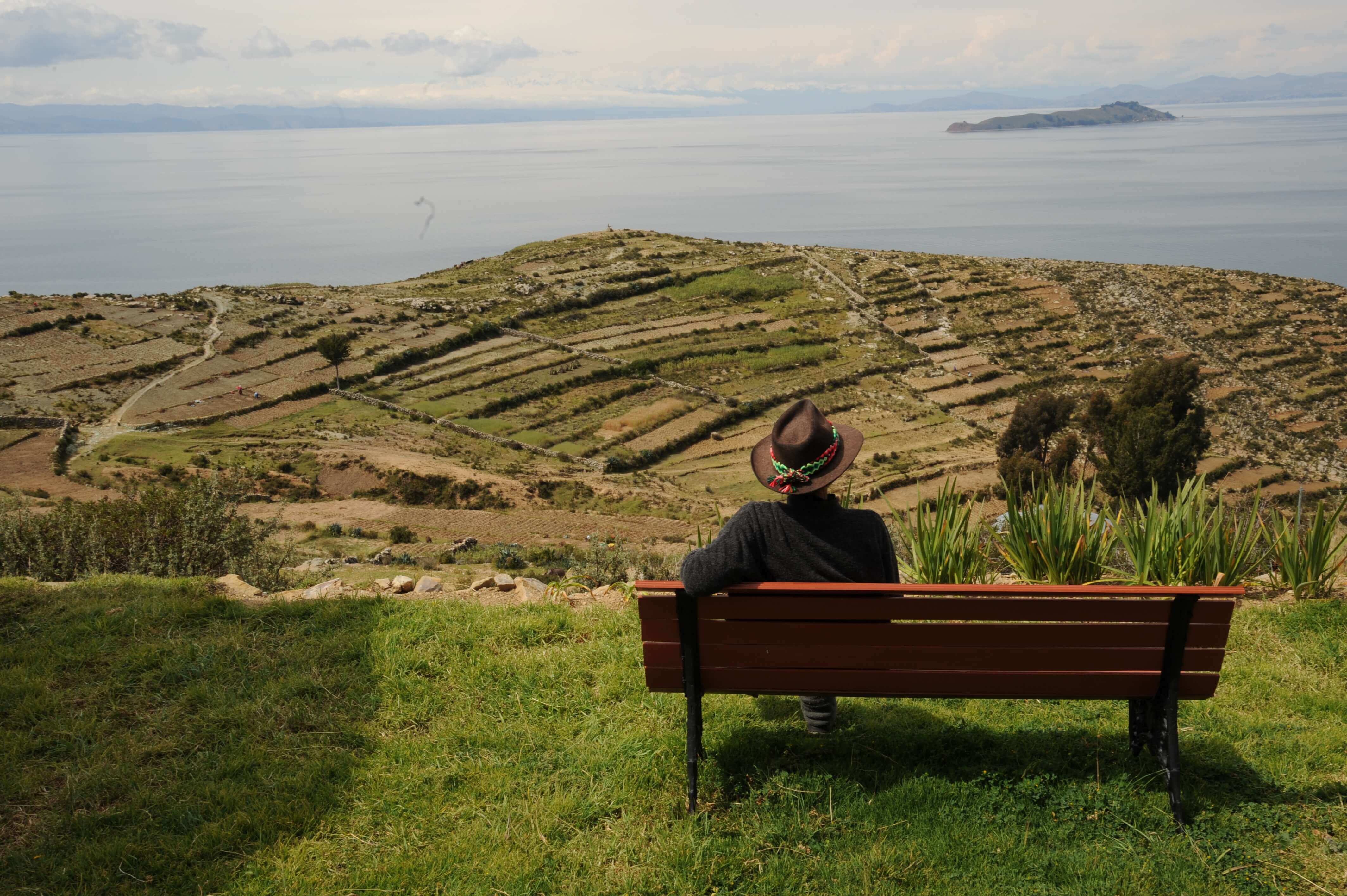 Terraced hills overlook the calm waters of Lake Titicaca in Bolivia's highlands. 