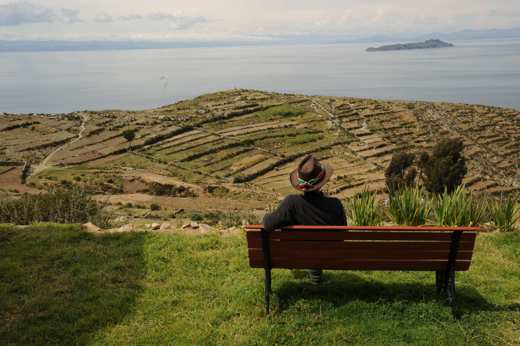 Terraced hills overlook the calm waters of Lake Titicaca in Bolivia's highlands. 