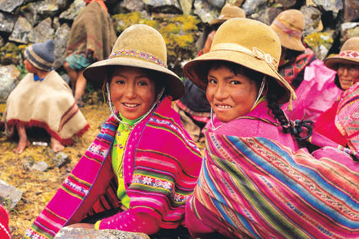 Smiling Peruvian girls in colourful traditional clothing, Sacred Valley Cultural Heritage. 