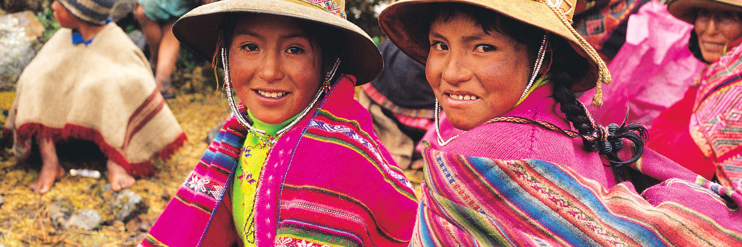 Smiling Peruvian girls in colourful traditional clothing, Sacred Valley Cultural Heritage. 