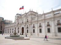 The grand facade of La Moneda Palace, the presidential seat of Chile, located in the heart of Santiago with the Chilean flag. 