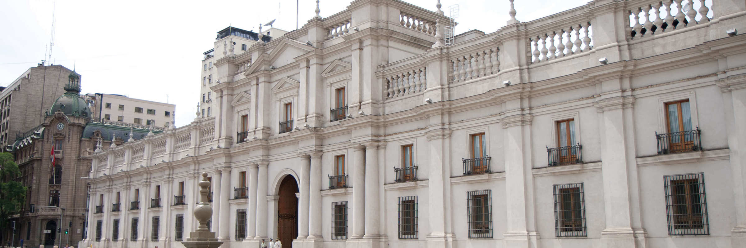 The grand facade of La Moneda Palace, the presidential seat of Chile, located in the heart of Santiago with the Chilean flag. 