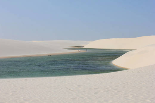 Stunning view of the white sand dunes and a turquoise rainwater lagoon at Lencois Maranhenses National Park, Maranhao, Brazil. 