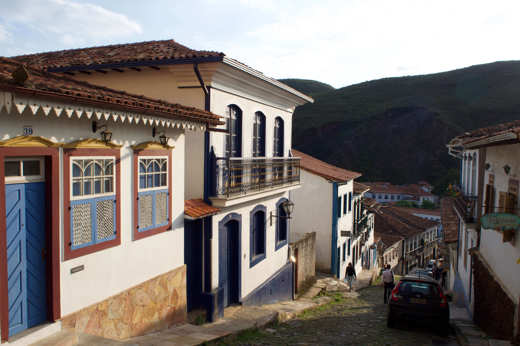 Colonial cobbled street with colourful colonial houses in Ouro Preto, Minas Gerais, Brazil. 