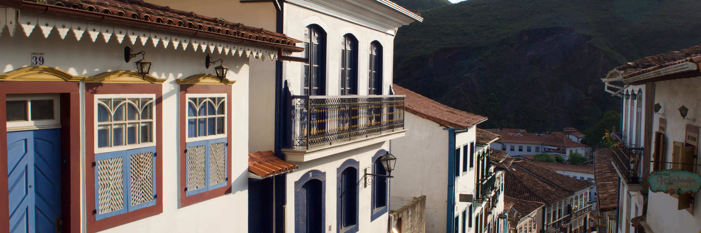 Colonial cobbled street with colourful colonial houses in Ouro Preto, Minas Gerais, Brazil. 