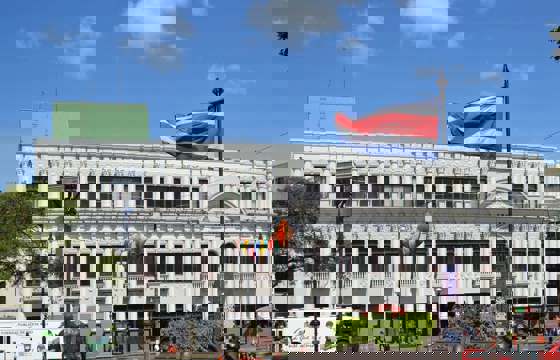 A grand historic building in downtown San Jose, proudly flying the Costa Rican flag, reflects the capital's cultural and political heritage.