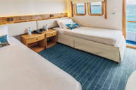 A spacious outside facing junior twin cabin on Coral I