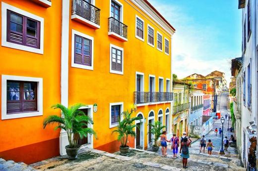 Colourful colonial buildings on a cobbled street in Sao Luis, Maranhao, Brazil, with people walking in the historic centre.