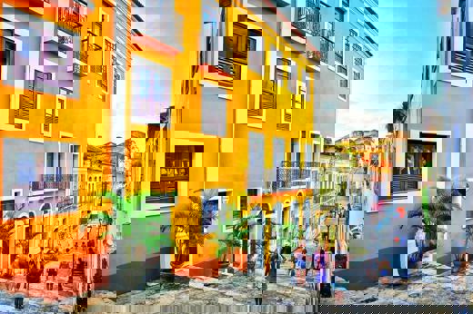 Colourful colonial buildings on a cobbled street in Sao Luis, Maranhao, Brazil, with people walking in the historic centre.