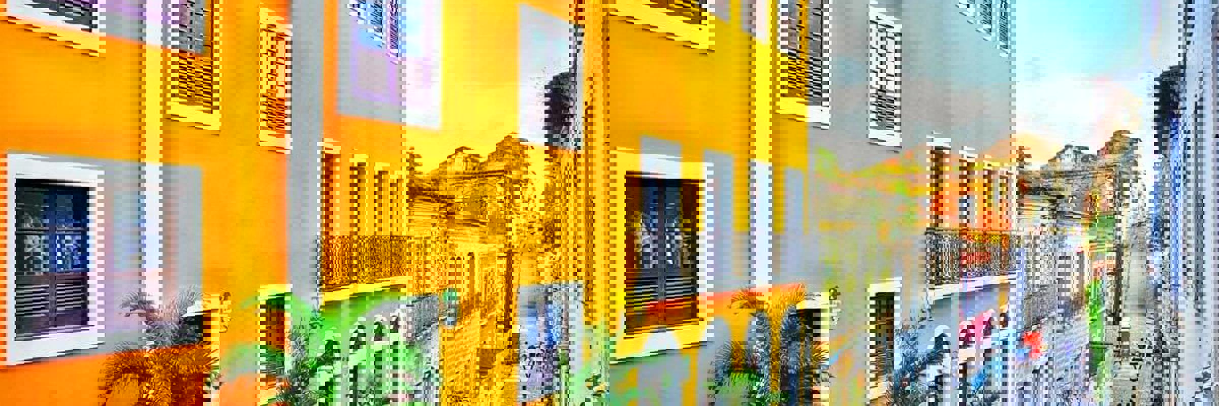 Colourful colonial buildings on a cobbled street in Sao Luis, Maranhao, Brazil, with people walking in the historic centre.